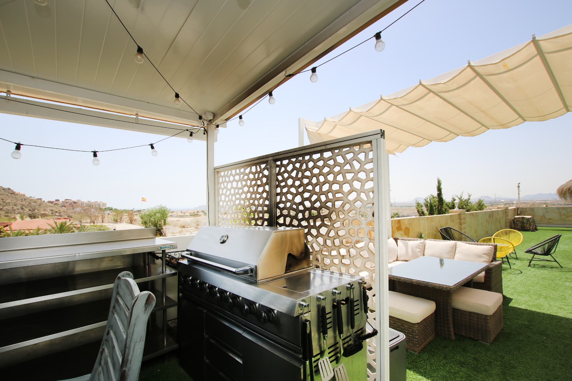 The outdoor kitchen and grill beside the terrace lounge, looking out over the valley