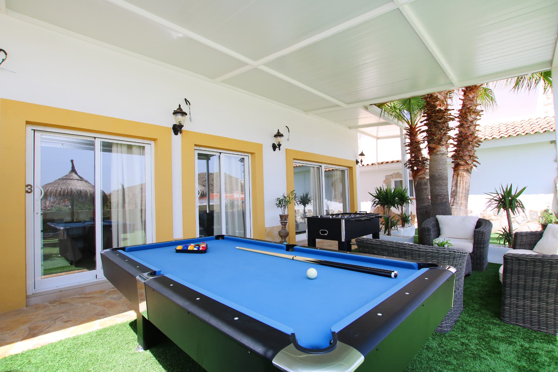 The games terrace with billiards table, futbolin and lounge seating