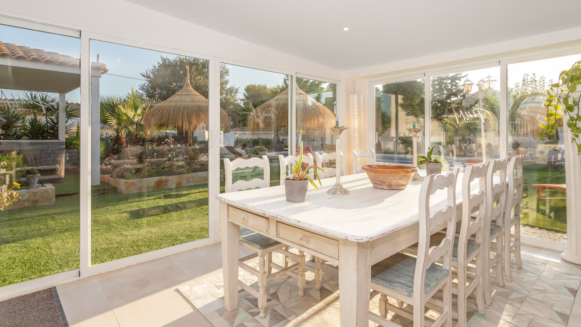 The indoor dining table beside the kitchen, looking out to the garden