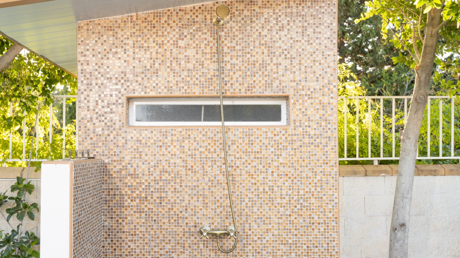 The outdoor shower in the garden beside the pool terrace